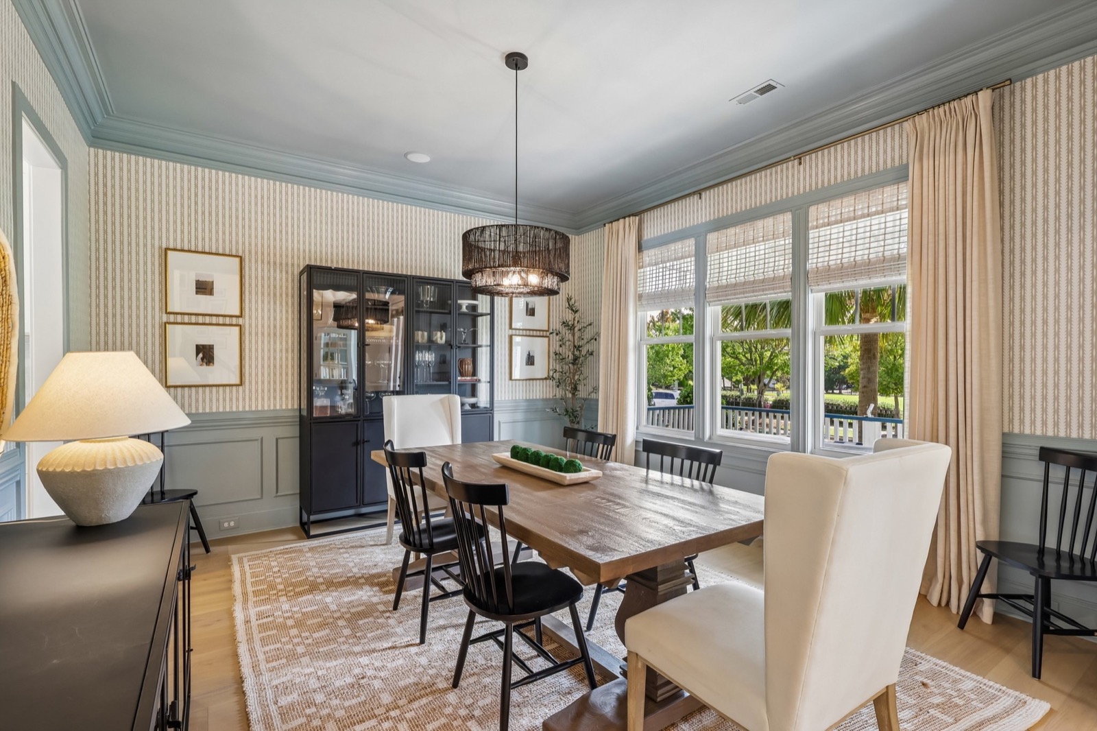 Sunlit dining space with large windows