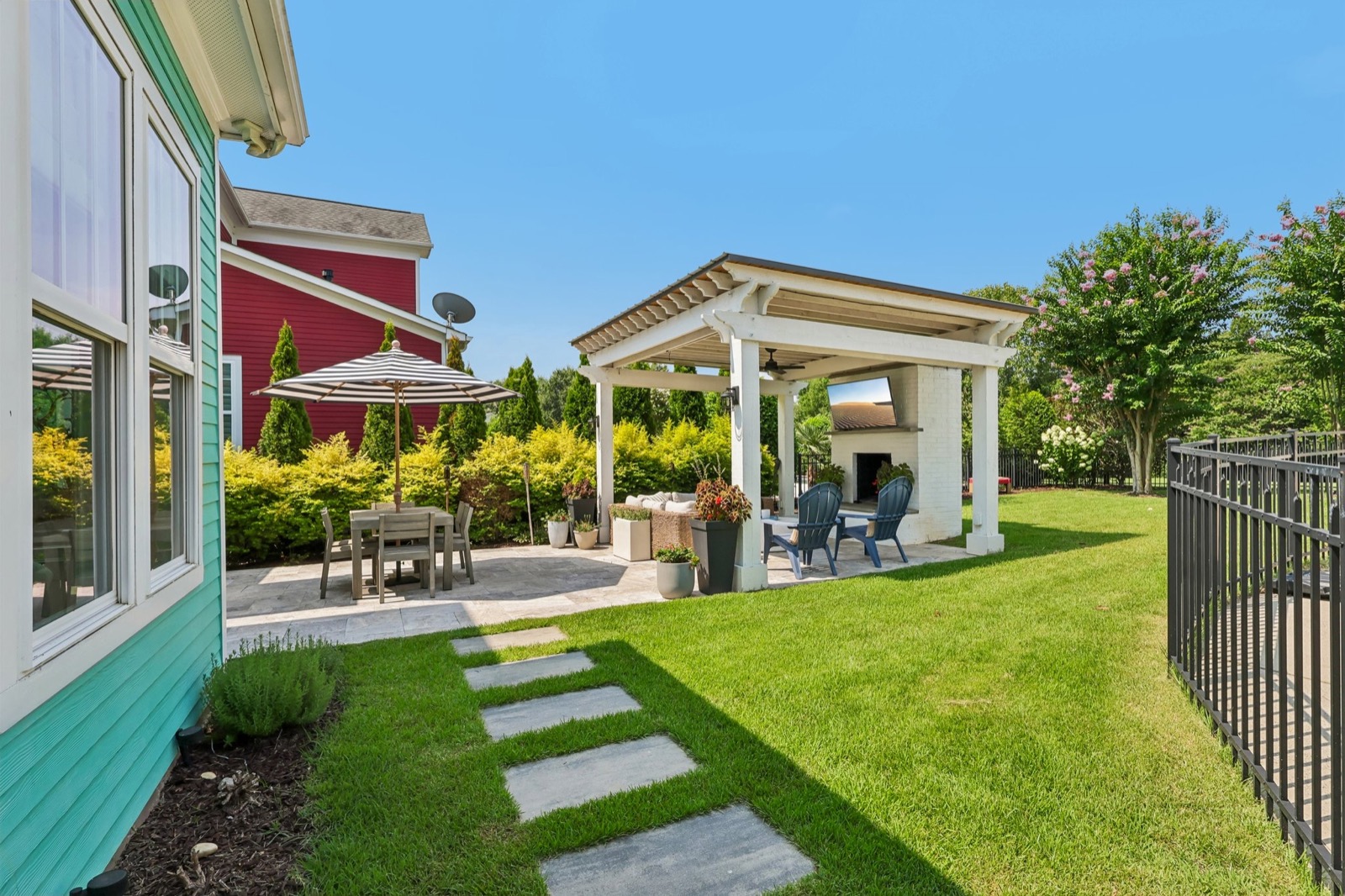 Travertine patio and lush professionally landscaped backyard