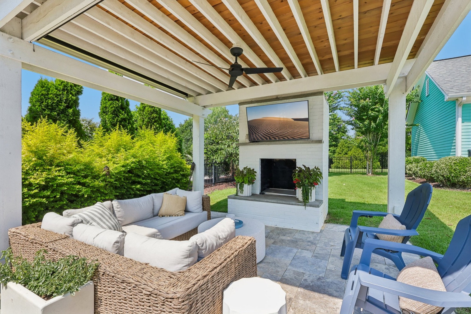 Covered outdoor living with custom pergola and outdoor fireplace